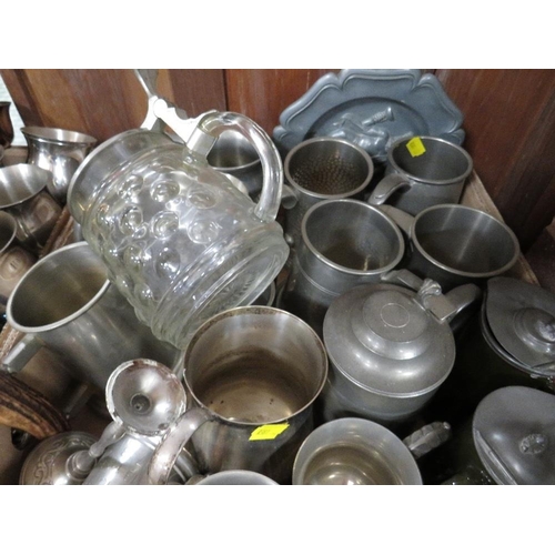 135 - Four trays of assorted metal ware to include pewter tankards, silver plated placemats, flatware etc