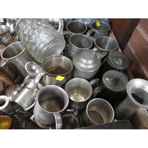 135 - Four trays of assorted metal ware to include pewter tankards, silver plated placemats, flatware etc