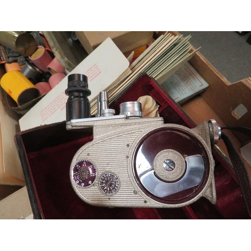 145 - A tray of vintage photographic items to include a cased Bell & Howell cine camera