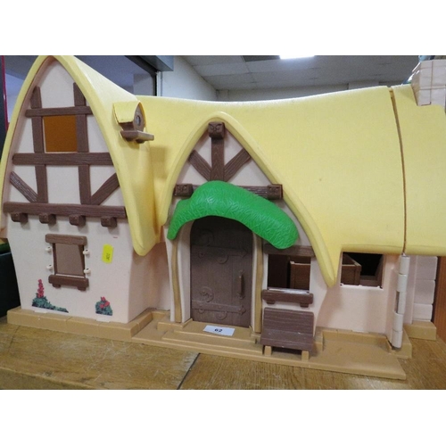 62 - A vintage Disney Snow White and the Seven Dwarfs cottage with figures and furniture