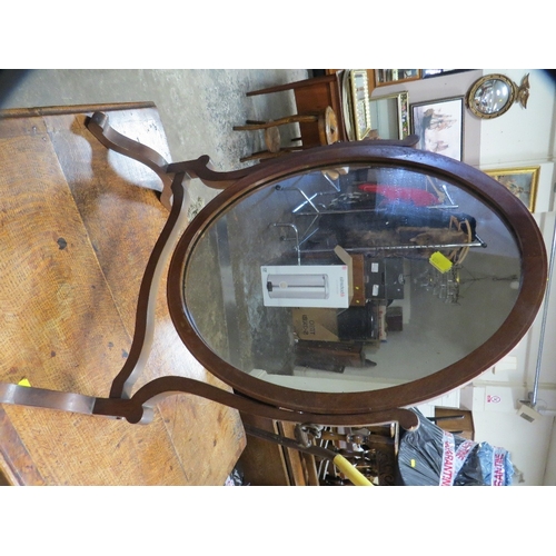 832 - An Edwardian swivel inlaid oval mirror