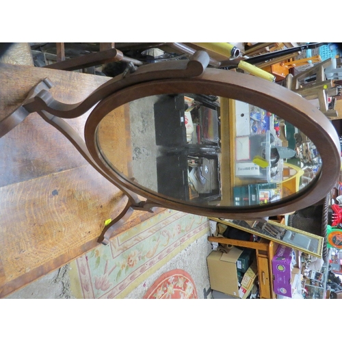 832 - An Edwardian swivel inlaid oval mirror