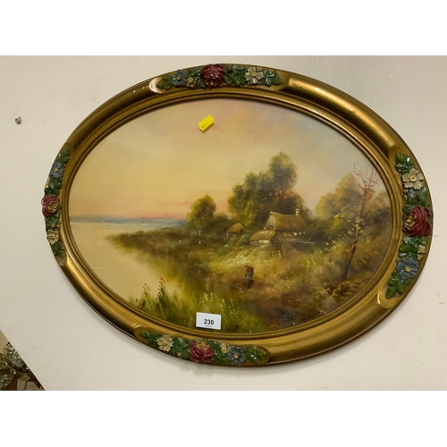 230 - An oval oil painting of a River landscape with a figure by the bank