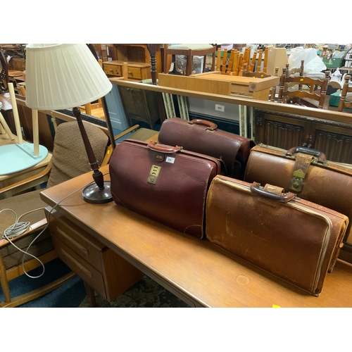 856 - A retro cowhide case to go with another similar and a mahogany table lamp with three modern baskets