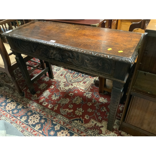 An antique oak carved hall console table with single drawer W 107 cm