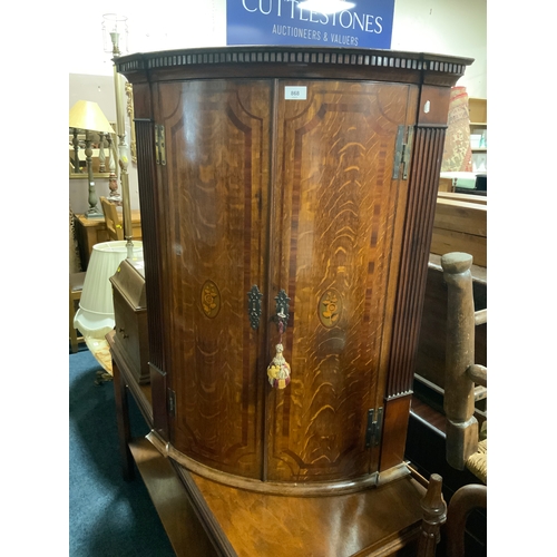 868 - An antique oak and mahogany inlaid hanging corner cupboard