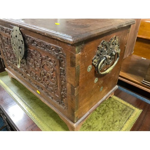 872 - A small carved eastern style box with elaborate twin handles W 69 cm