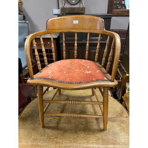 877 - An antique oak spindle back armchair