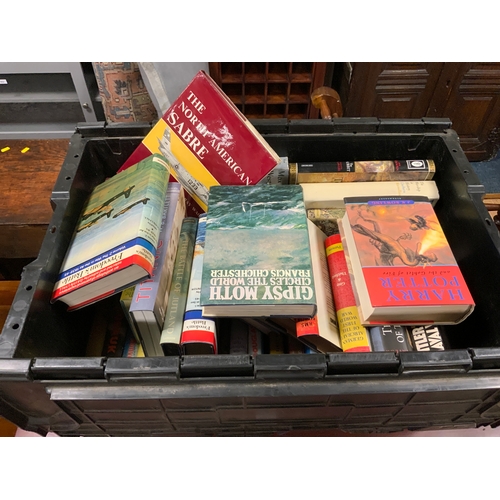 879 - A large black crate of assorted books to include Harry Potter