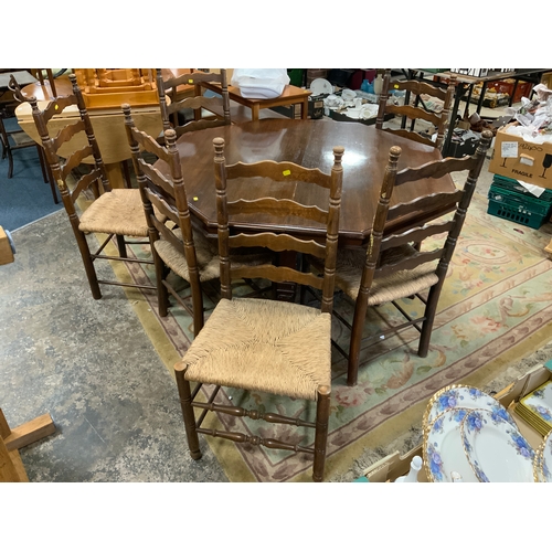 888 - A carved Edwardian oak octagonal table together with six later ladderback wicker seat chairs Table D... 