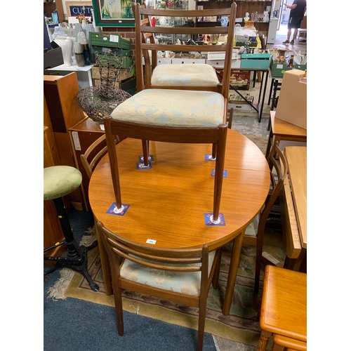 890 - A mid-century teak extending dining table together with six chairs