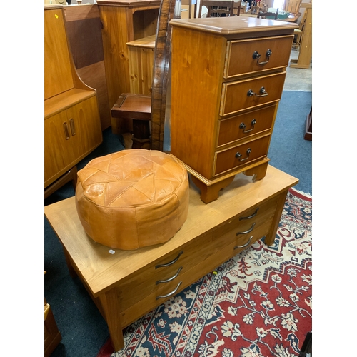 894 - A light oak four drawer media cabinet together with a four drawer chest and an eastern pouffe