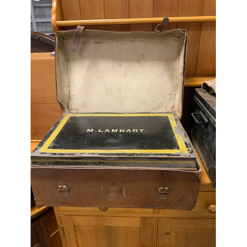 914 - A vintage leather covered tin trunk addressed to M Lambart together with another tin trunk etc.