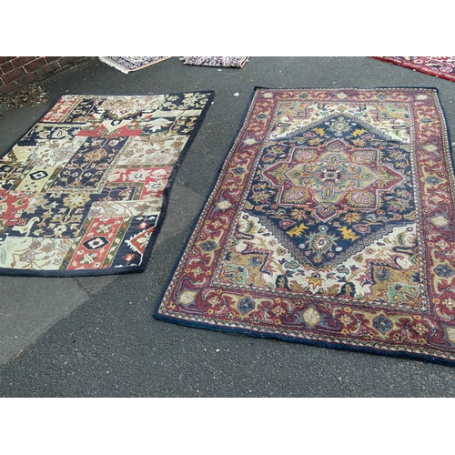 925 - Two large 20th century woollen multicoloured rugs - largest 241 x 148 cm