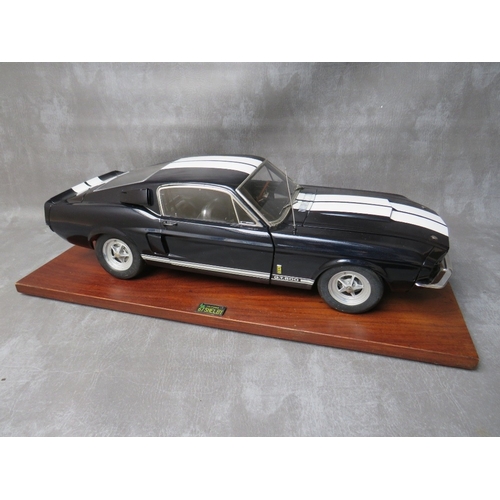 85 - A DE AGOSTINI 1:8 SCALE DIE CAST MODEL OF A FORD MUSTANG 1967 SHELBY GT500, on a mahogany wooden sta... 