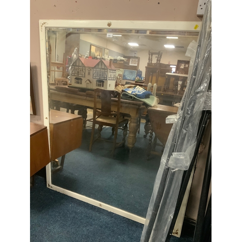 711 - A large wooden framed wall mirror 140 x 122 cm