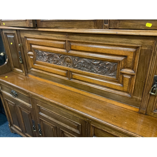 713 - A large Edwardian carved oak display cabinet - stamped ‘Thos Turner Manchester’ to the drawer H 244 ... 