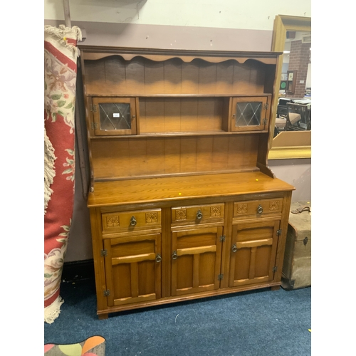 724 - An oak linen fold glazed dresser