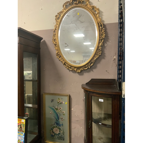 730 - A modern oval gilt frame mirror together with a needlework picture