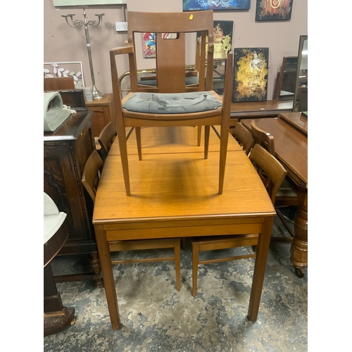 739 - A mid-century teak extending dining table together with six chairs A/F