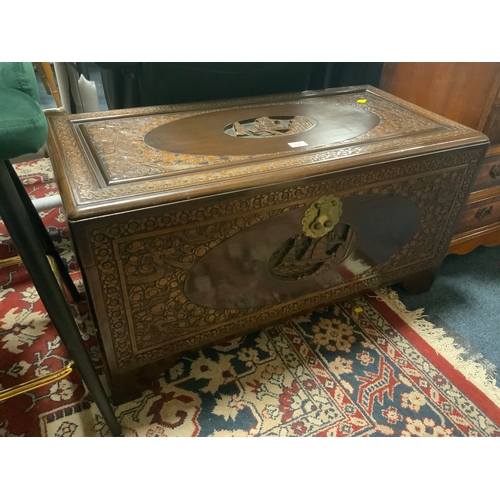 744 - A carved eastern hardwood coffer W 94 cm