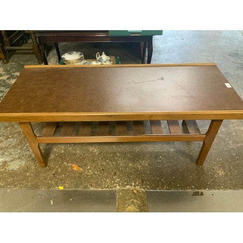 768 - A mid-century teak two tier table with Formica top