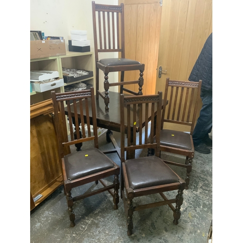 797 - A vintage oak draw leaf table and four chairs