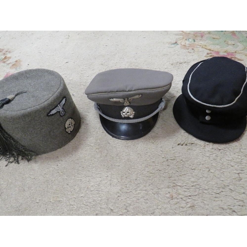 130 - Three reproduction German WW2 headdresses