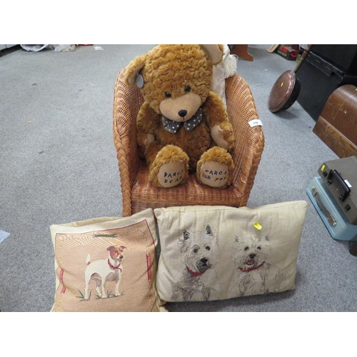 156 - A wicker teddy bear chair together with a Darcy bear and cushions