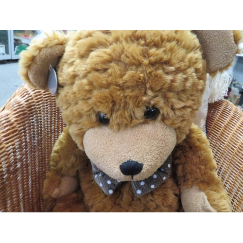 156 - A wicker teddy bear chair together with a Darcy bear and cushions