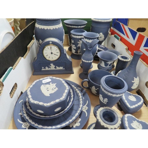 167 - A tray of dark blue Wedgwood Jasperware to include vases, desk clock together with a tray of assorte... 