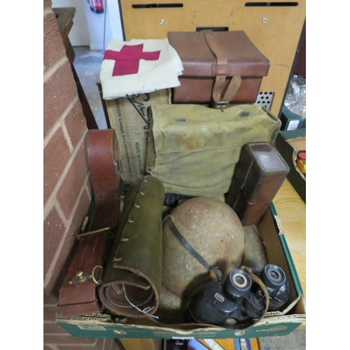 79 - A tray of militaria to include steel helmet, binoculars, WW2 gas mask, Sam Browne belt etc