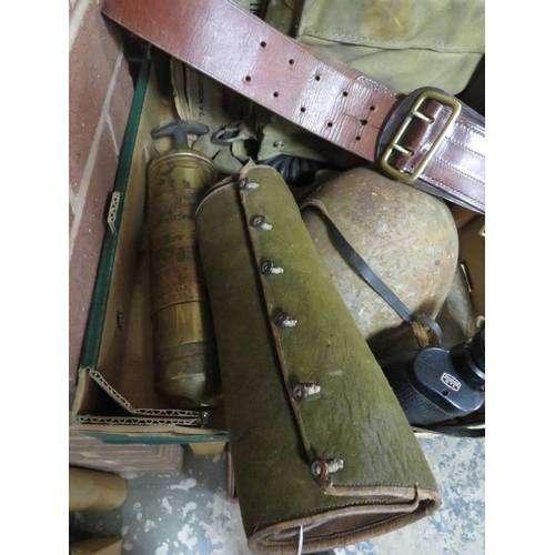 79 - A tray of militaria to include steel helmet, binoculars, WW2 gas mask, Sam Browne belt etc