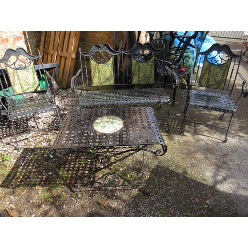 610 - A wrought iron garden set consisting of a table, two chairs and a bench