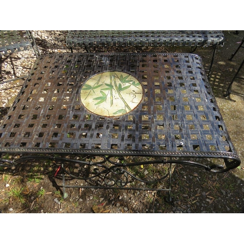 610 - A wrought iron garden set consisting of a table, two chairs and a bench