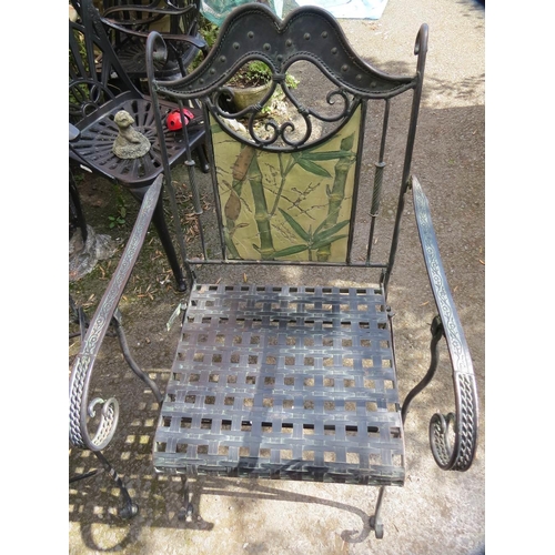 610 - A wrought iron garden set consisting of a table, two chairs and a bench