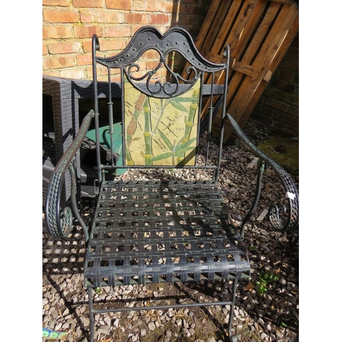 610 - A wrought iron garden set consisting of a table, two chairs and a bench