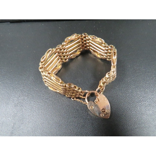 444 - A hallmarked 9 carat gold gate bracelet with spare links approx. total weight 25.3g