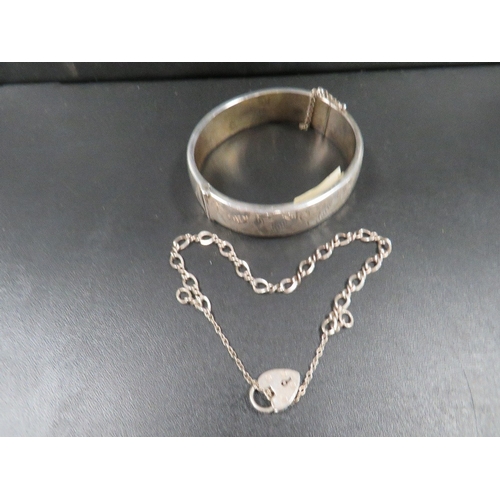 453 - A hallmarked silver clasp bangle with a silver bracelet