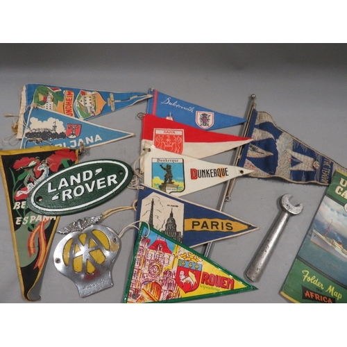 493 - A collection of vintage pennants, car mascot flag, AA car badge etc.