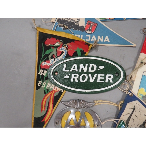 493 - A collection of vintage pennants, car mascot flag, AA car badge etc.