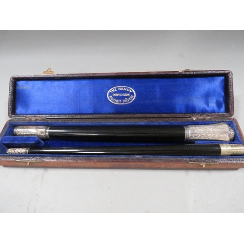 520 - A cased two piece hallmarked silver mounted conductors baton engraving from 1902