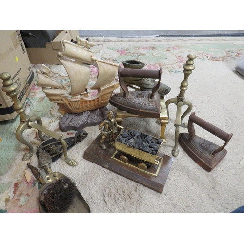 128 - A tray of assorted metal ware to include a cannon, sail ship door stop, fire dogs etc