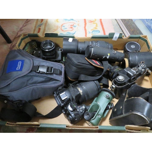 67 - A box of collectable cameras and lenses