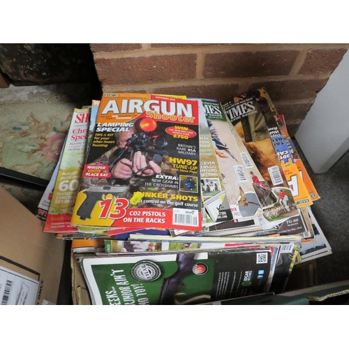 114 - A tray of shooting magazines together with a tray of shooting related items including cartridge belt