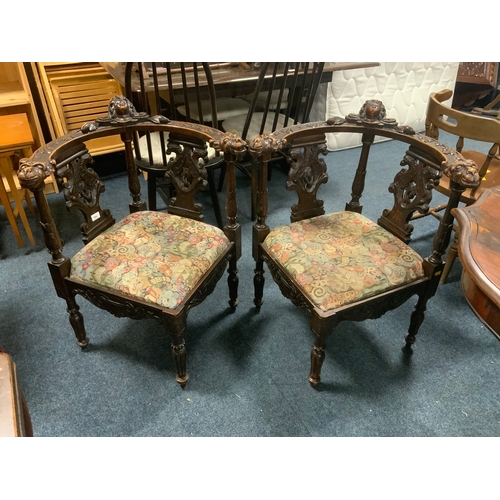 806 - A pair of antique carved oak corner armchairs with mask head detail