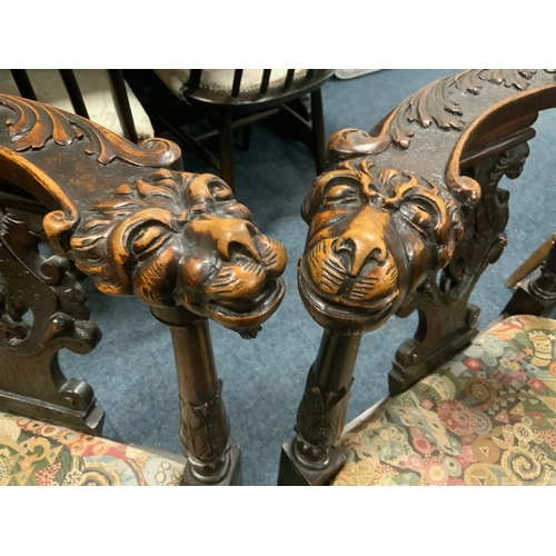 806 - A pair of antique carved oak corner armchairs with mask head detail