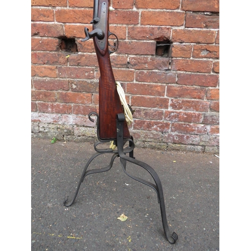 115 - A vintage flintlock rifle converted to a standard lamp with bent wrought iron base