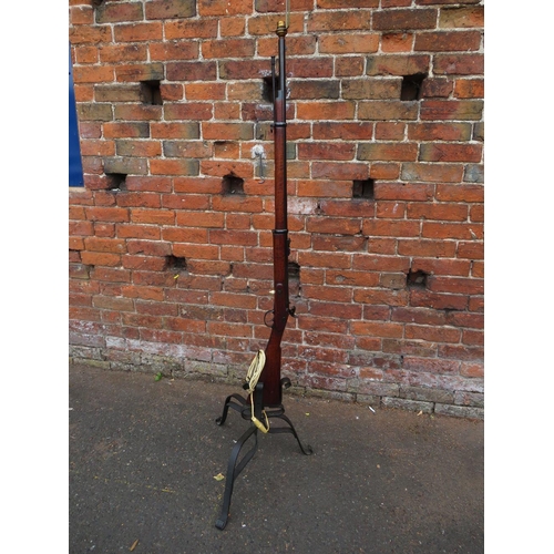 115 - A vintage flintlock rifle converted to a standard lamp with bent wrought iron base