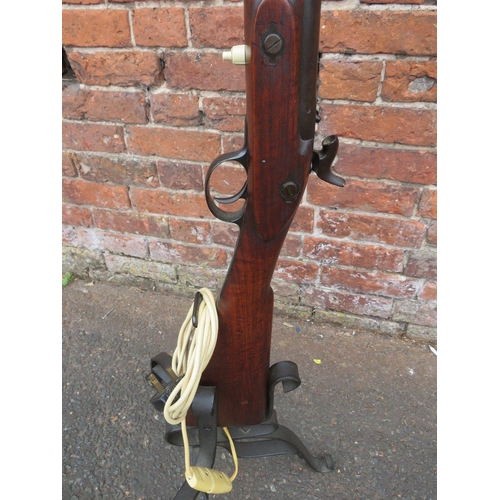 115 - A vintage flintlock rifle converted to a standard lamp with bent wrought iron base